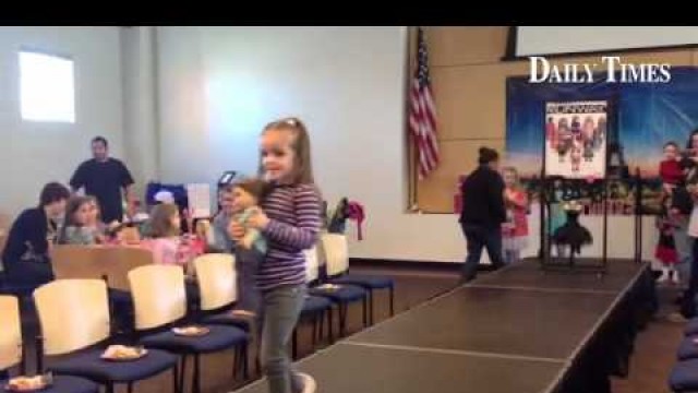 'Girls participate in the American Girl doll Runway Fashion Show at the Farmington Public Library on'