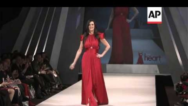 'Celebrities walk the catwalk in red dresses for charity'